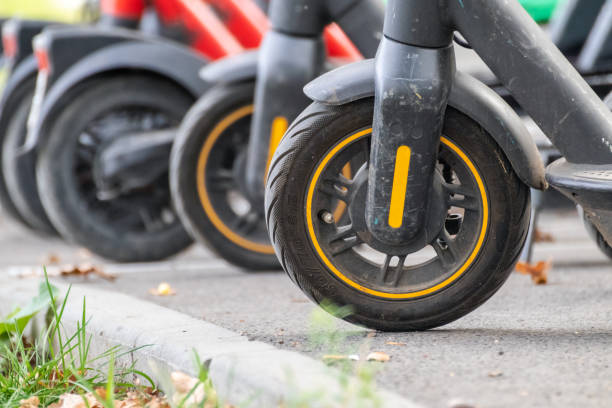 istock Electric Scooters parking, wheels close-up 1445987110