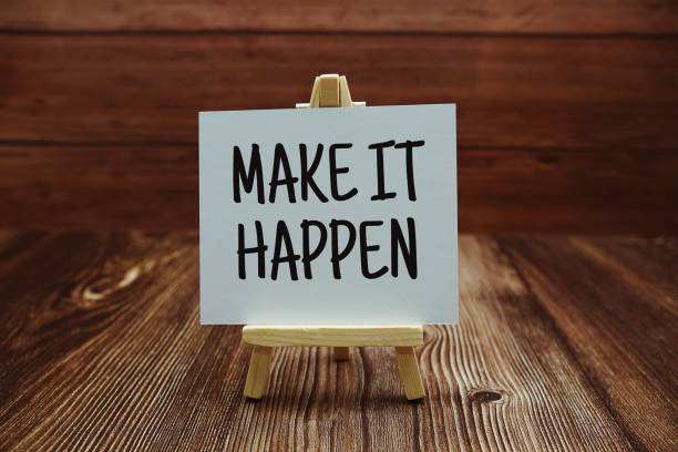 istock Make it Happen text on paper card on wooden background 1445988775