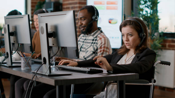 istock Woman with physical disability working at call center 1445990311