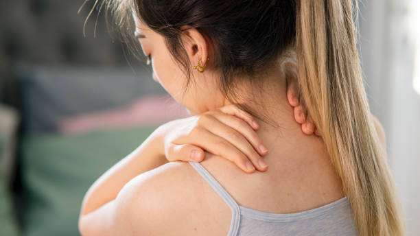 istock Moody young woman holding her neck 1445990491