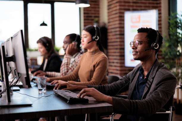 istock Helpline operator with chronic impairment sitting in wheelchair 1445991423