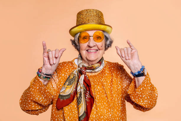 istock Cheerful grandmother does call me shaka hand sign gesture 1445992480