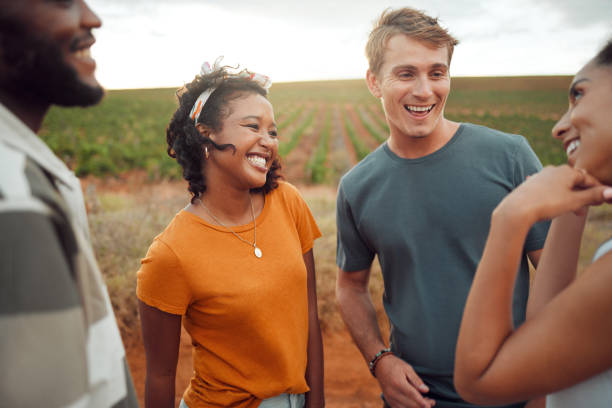 istock Communication, comic and friends talking in nature while on holiday together in summer. Group of young, happy and funny people speaking during travel, adventure and walk in countryside on vacation 1445992564
