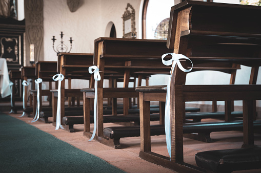 Chaple benches decorated with white bows