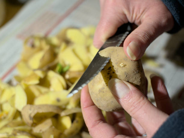 istock Potatoes peeling with a peeler 1445993001