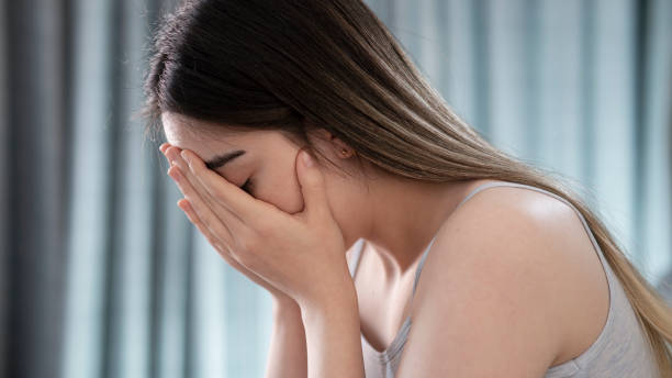 istock Sad tired young woman touching forehead having headache migraine or depression 1445993011