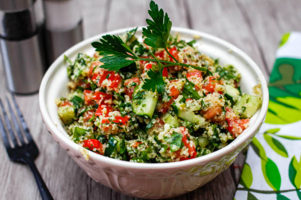Tabouleh Salad Close-Up Tabouleh Salad Close-Up bulgur wheat stock pictures, royalty-free photos & images