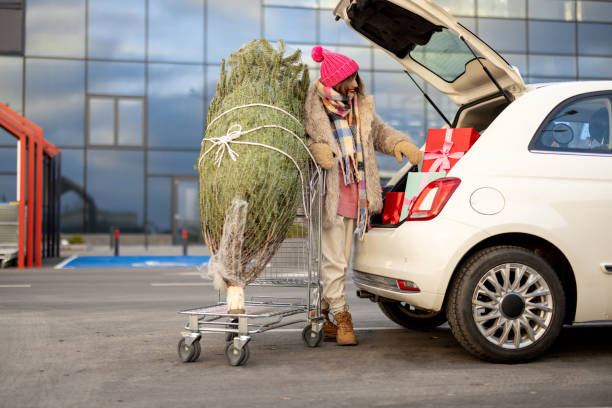 istock Woman buys presents and Christmas tree at mall 1445994569