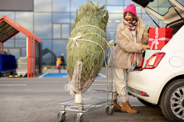 istock Woman buys presents and Christmas tree at mall 1445994592