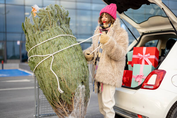 istock Woman buys presents and Christmas tree at mall 1445994633