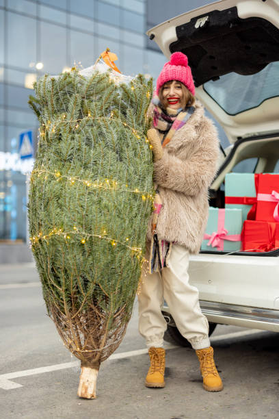 istock Woman buys Christmas tree and presents at mall 1445994768