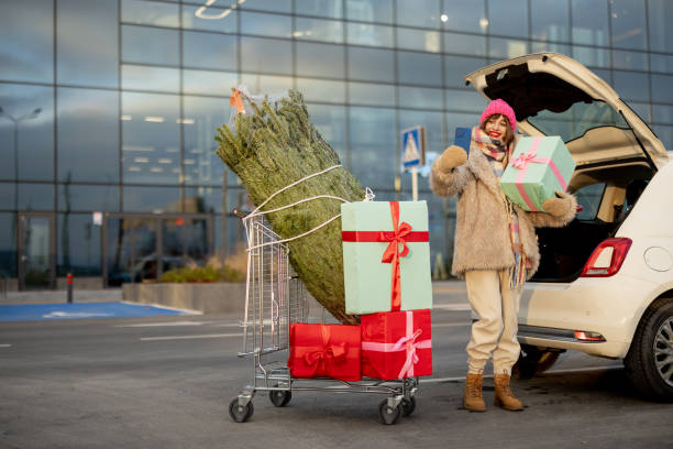 istock Woman buys Christmas tree and presents at mall 1445994896