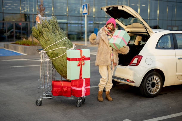 istock Woman buys Christmas tree and presents at mall 1445994906