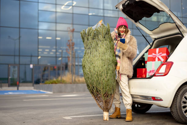 istock Woman buys Christmas tree and presents at mall 1445995749