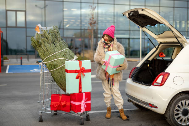 istock Woman buys Christmas presents and tree at mall 1445995921