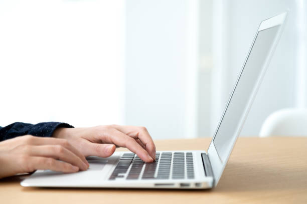 istock Close up of hands typing laptop. Selective focus on hands. Copy space. 1445997322