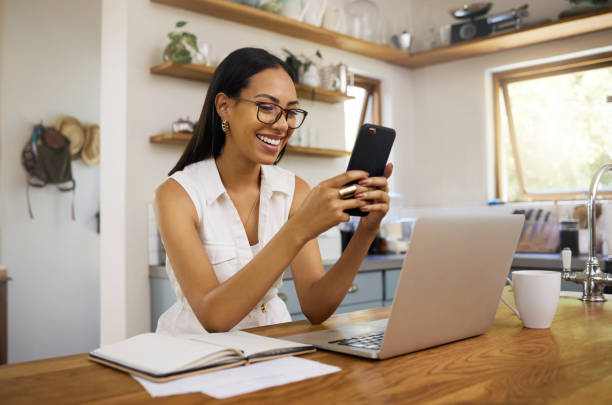 istock Remote work, home and business woman with phone for communication, connection and typing while smile, happy and relax. Entrepreneur, excited and with laptop for planning, startup company or strategy. 1445997500