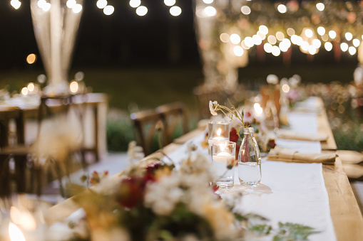 istock Wedding reception night dinner setup table with beautiful flower decoration. 1445999589