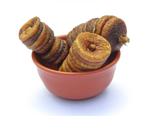 istock Dried figs or anjeer in a bowl isolated on white background 1446003744