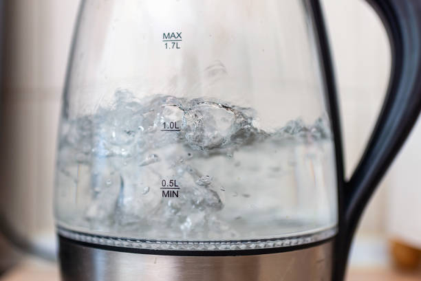 istock Transparent electric kettle with boiling water on the table in a kitchen.Closeup,selective focus. 1446004173