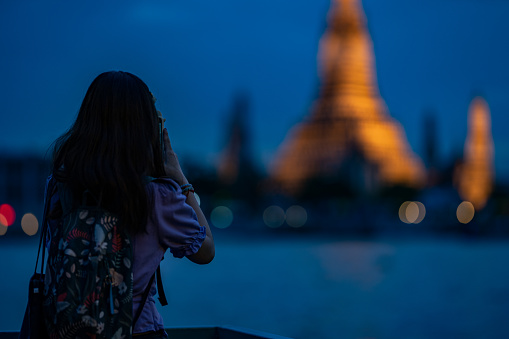 Asian tourist taking photo of a popular destination in Bangkok, Thailand