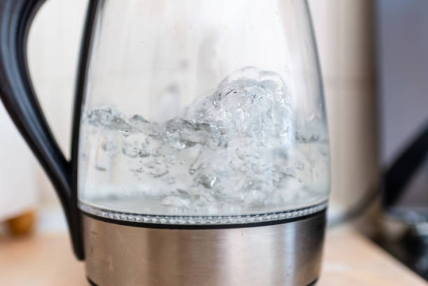 istock Transparent electric kettle with boiling water on the table in a kitchen.Closeup,selective focus. 1446004224