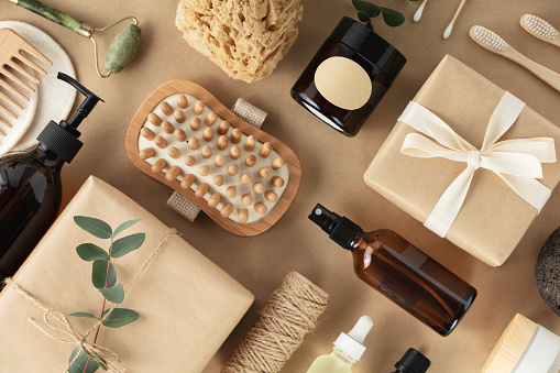 Flat lay composition with eco friendly personal care products on beige background with leaves shadows
