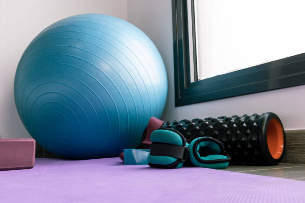 istock background with a yoga mat, pilates ball, weights, elastic bands. 1446005817