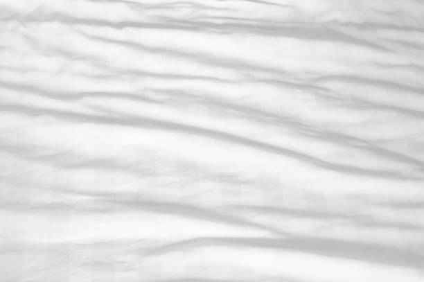 istock White wrinkled bedding sheet with pattern after guest's use taken in hotel room with copy space, Untidy blanket background texture 1446007774