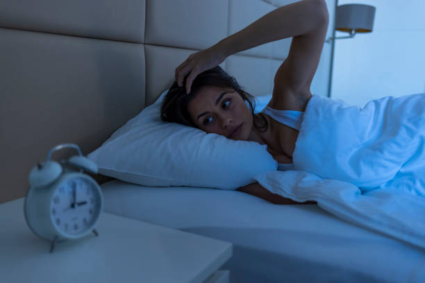 Sleepless woman suffering from insomnia, sleep apnea or stress. stock photo