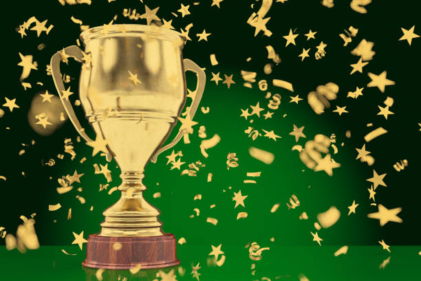istock Winning a Championship Concept Golden Trophy Cup with Star Shaped Confetti 1446014515