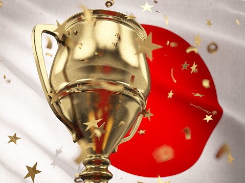 Japan Championship Concept Star Shaped Confetti Falling Onto A Gold Trophy Cup with Japanese Flag. 3D Render