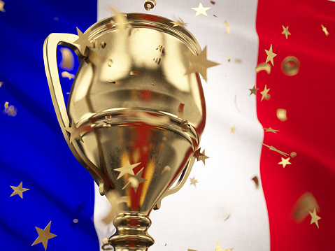 France Championship Concept Star Shaped Confetti Falling Onto A Gold Trophy Cup with French Flag. 3D Render