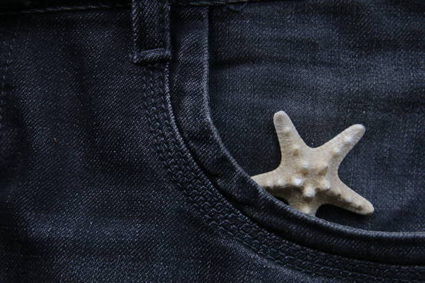 Starfish in your pocket. Summer travel concept. stock photo