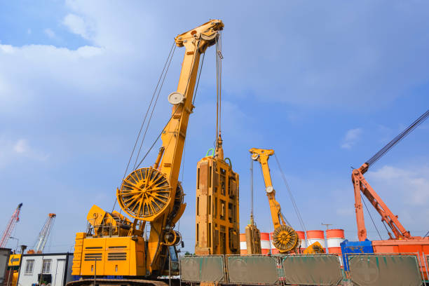 istock Earth drilling crawler crane with hydraulic diaphragm wall equipments  working in road construction site for overpass construction project 1446019033