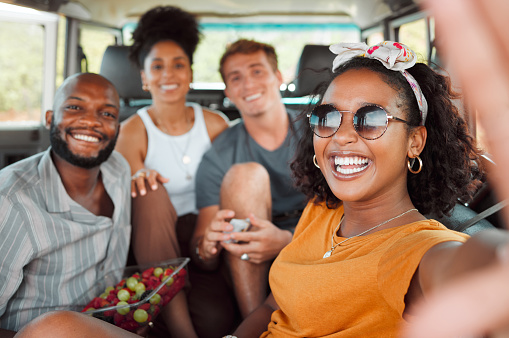 Selfie, smile and friends on a road trip in car for travel adventure together. Portrait of happy, excited and young group of people with photo for social media in a van for transport while on holiday