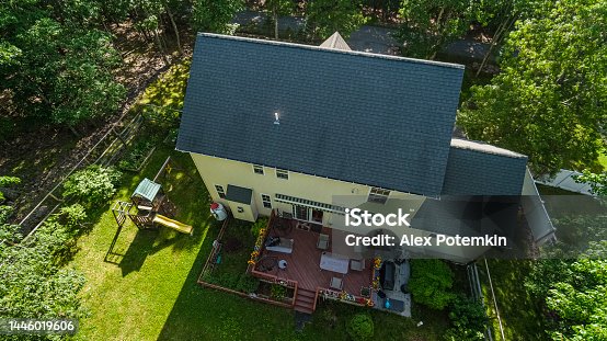istock Detached one-family house in a residential community with patio and playground, view from above on a summer day in Poconos, Pennsylvania. 1446019606