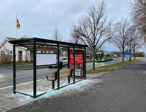 Vandalized bus station or bus stop in a rich neighbourhood of Malmo. Glass windows of a bus stop in Malmö have been vandalised or shattered on the routes 6 and 4, nearby ICA in Bunkeflostrand centrum. Bunkeflostrand used to be a calm neighborhood