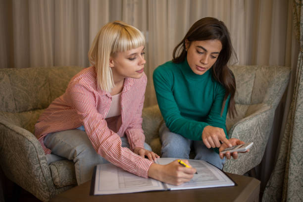 istock Sisters calculate family budget 1446021281