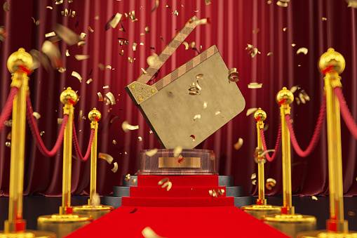 Movie Award Concept Director's Clapper Board Trophy on a Podium with Red Carpet and Confetti. 3D Render
