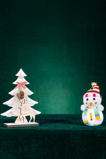istock christmas tree and snowman on green background with empty space in the middle at vertical composition 1446023544