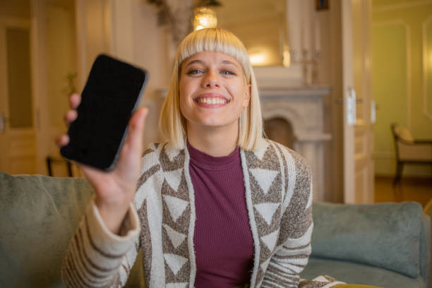 istock Happy young woman using phone 1446026048
