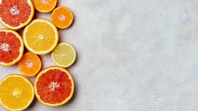 Frame with orange, grapefruit, lemon and mandarin at bright background