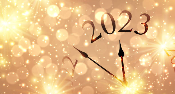 istock New year clock showing 2023 with golden firework and bokeh lights. 1446028654