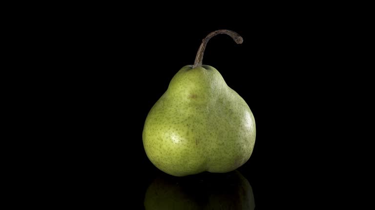 Fruit whole pear Spinning and Rotating Isolated on black Background