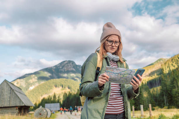 istock Dissatisfied woman hiker, searching right direction on map while taking a hiking break, having fun and relaxing while spending autumn day outdoors. 1446031186