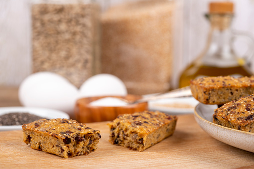 Muesli bar, fitness bar home baked with ingredients in background