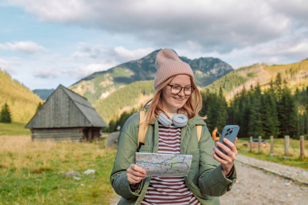 istock Woman hiker, searching right direction on map while taking a hiking break, having fun and relaxing while spending autumn day outdoors. 1446031411