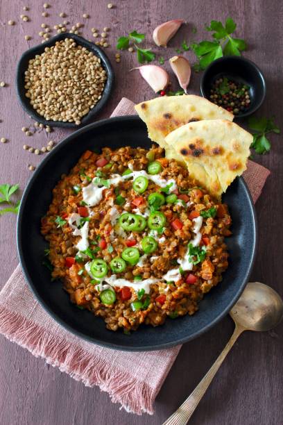 Lentil with vegetables served with naan bread.