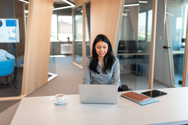 istock Young Hispanic woman using laptop while working in the office 1446032564
